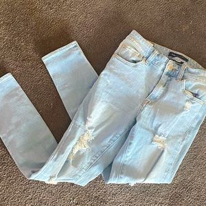 light blue jeans with rips.